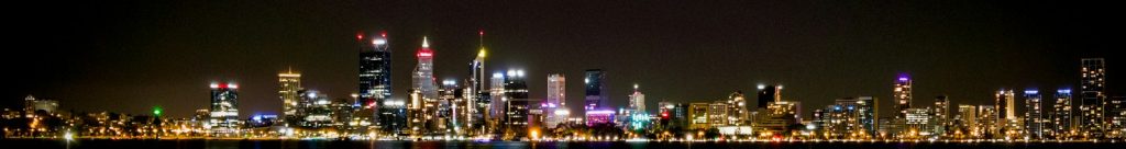 city lights reflecting on harbor at nighttime