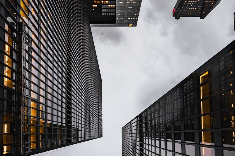 low angle photo of black high rise concrete city buildings